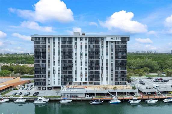 Front view of a multi-story apartment building by the water.