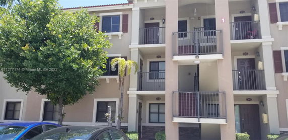 Front view of a multi-story residential building with balconies.