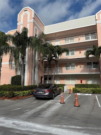 Front view of a multi-story residential building with balconies.