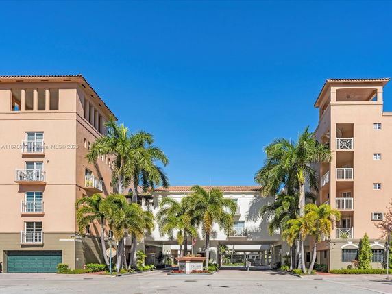 Front view of a residential building with multiple stories and balconies.
