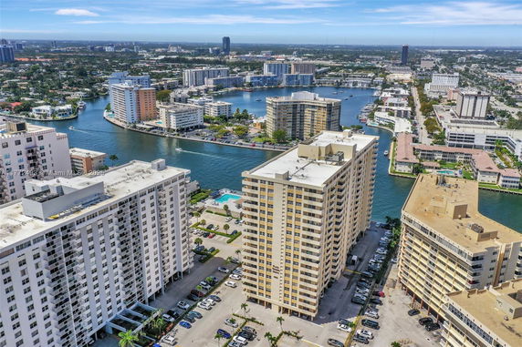 Panoramic view of a coastal cityscape with multiple high-rise buildings and waterways.