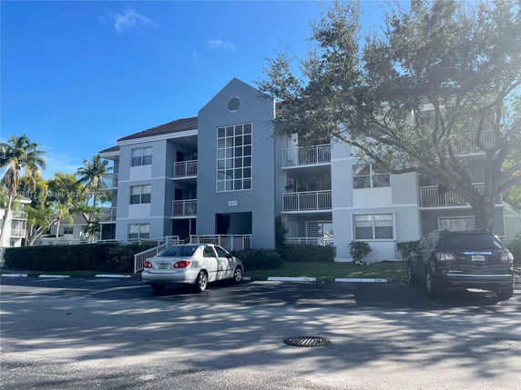 Front view of a multi-story residential building with balconies.