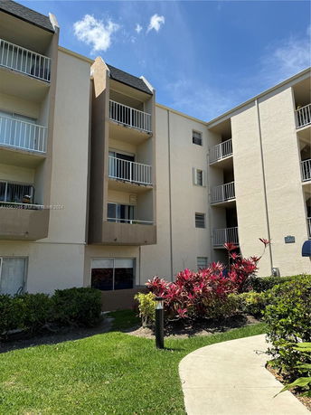 Front view of a multi-story apartment building with balconies.
