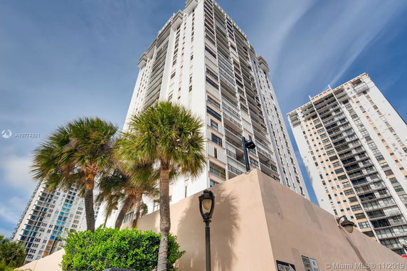Front view of a tall residential building with multiple stories.
