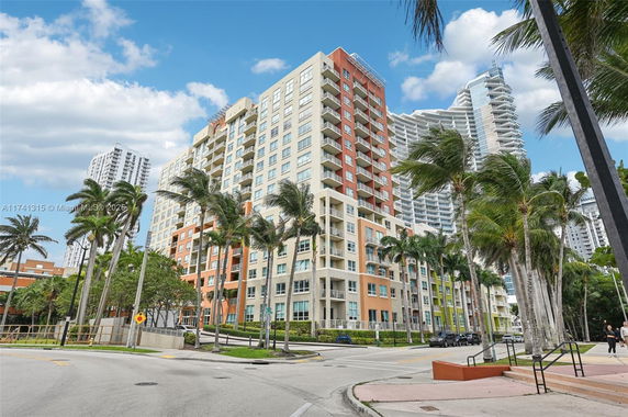 Front view of a multi-story residential building with balconies.