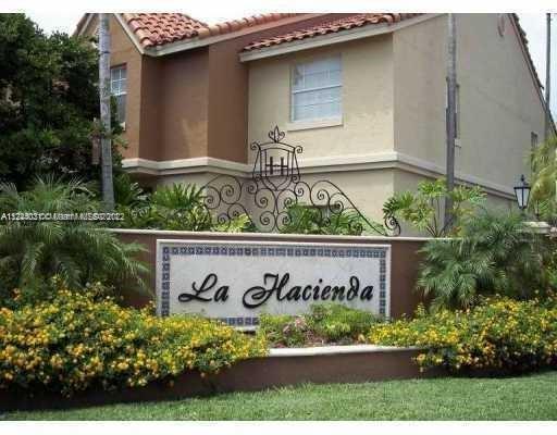 Front view of a house with a prominent sign displaying 'La Hacienda'.