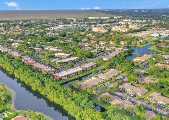 Panoramic aerial view of a suburban community with houses and greenery.