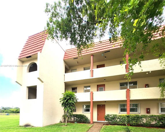 Front view of a multi-story building with red-tiled roof.