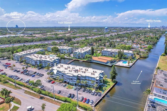 Panoramic view of a residential area with multiple buildings alongside a canal.