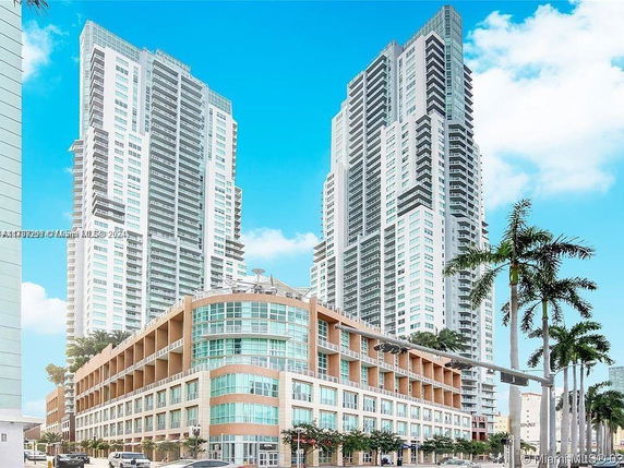 Front view of a modern multi-story building complex with two high-rise towers.