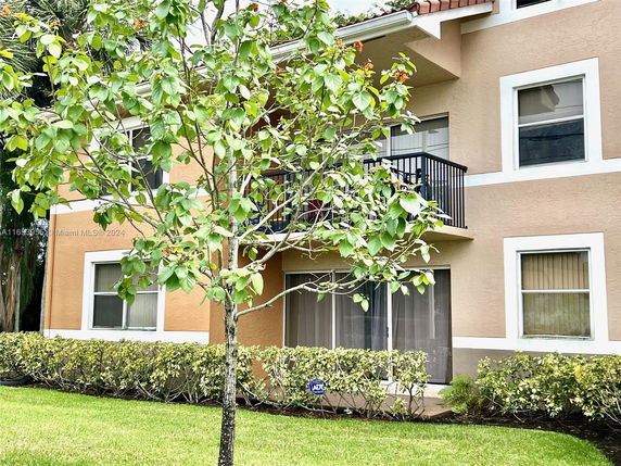 Front view of a two-story residential building with a balcony.