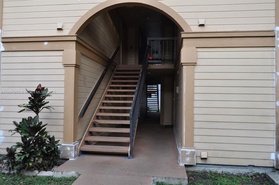 Front view of a building entrance with an exterior staircase.