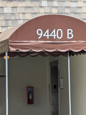 Entrance view of a building with an awning labeled 9440 B.