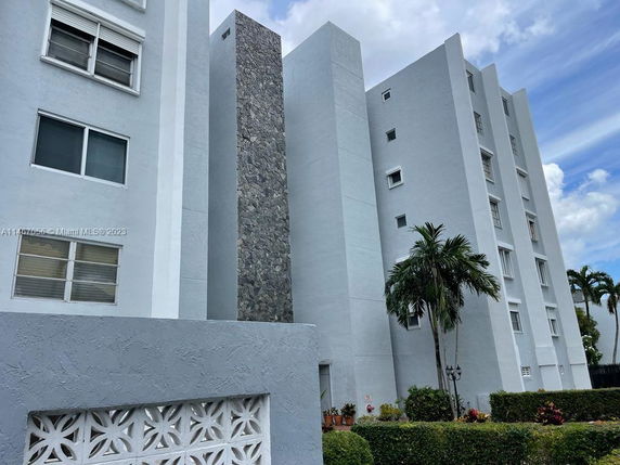 Front view of a multi-story residential building with stone accent.