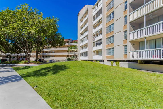 Front view of a multi-story residential building with balconies.