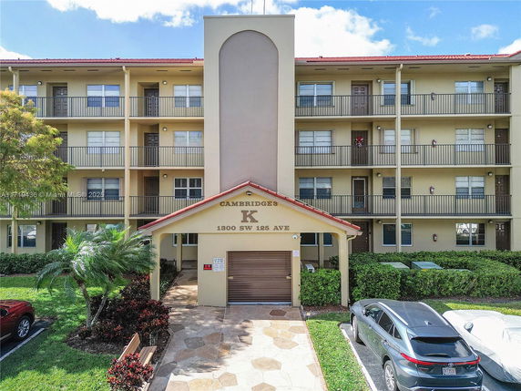 Front view of a multi-story residential building with balconies.