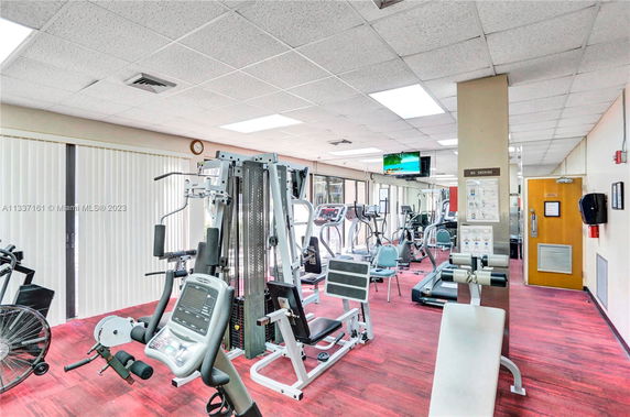 Indoor gym area with various exercise machines and equipment.