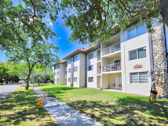 Front view of a multi-story residential building with balconies.