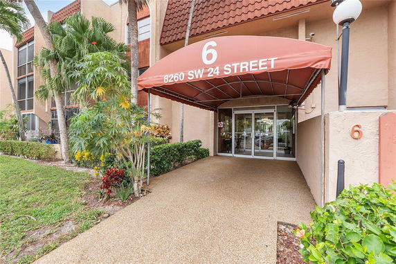 Entrance view of a building with an awning displaying the address '8260 SW 24 Street'.