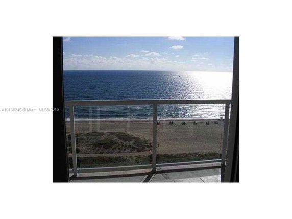 View from a building showing a beach and the ocean.