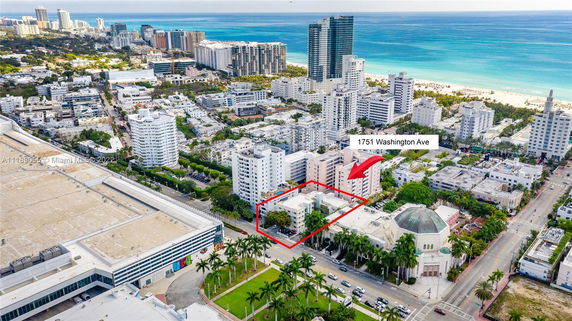 Aerial view of a cityscape with high-rise buildings near the coastline.