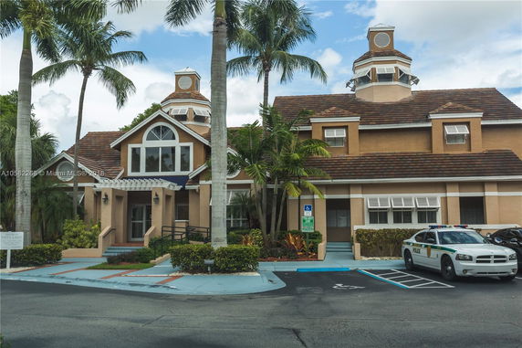 Front view of a two-story building with a distinctive roof design and multiple windows.
