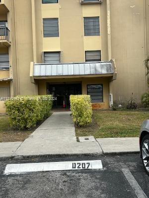 Front view of a multi-story building with a covered entrance.