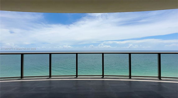 Panoramic view of the ocean from a balcony.