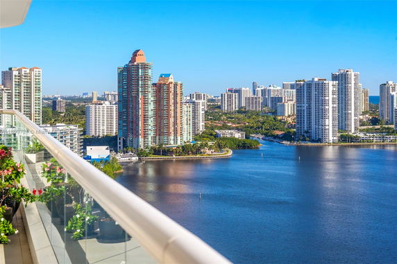 Panoramic view of a cityscape with buildings and a body of water.