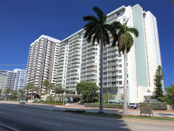 Front view of a multi-story residential building with balconies.