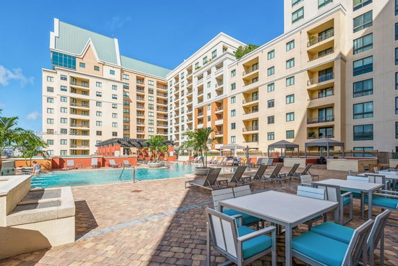 Outdoor pool area with surrounding multi-story residential buildings.