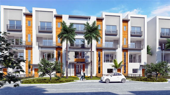 Front view of a modern multi-story apartment building with balconies and palm trees.