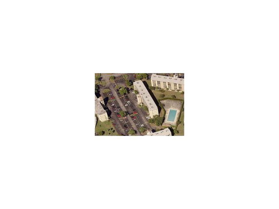 Aerial view of a residential complex with a central swimming pool.