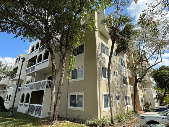 Front view of a multi-story residential building with balconies.