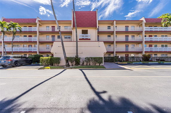 Front view of a multi-story residential building with balconies.