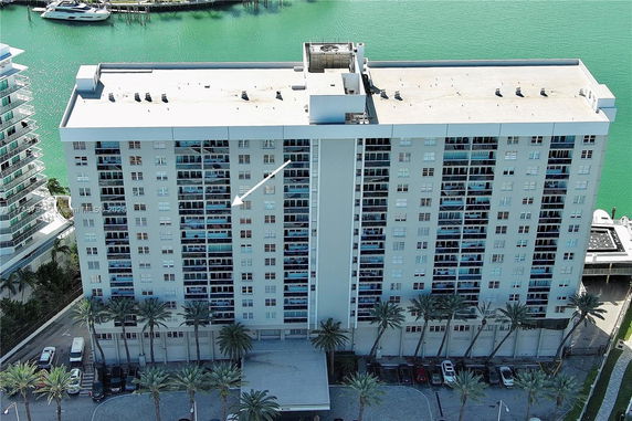 Front view of a multi-story apartment building near the waterfront.