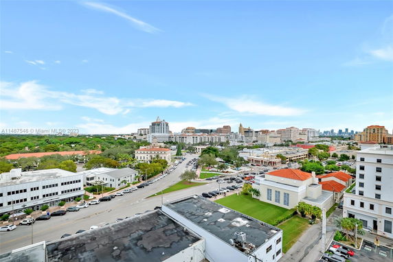 Panoramic view of a cityscape with various buildings and clear sky.