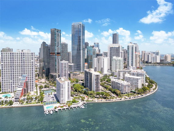 Panoramic view of a cityscape with high-rise buildings near a body of water.