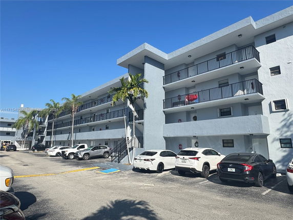 Front view of a multi-story residential building with balconies.