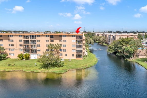 View of a multi-story apartment building next to a water body.