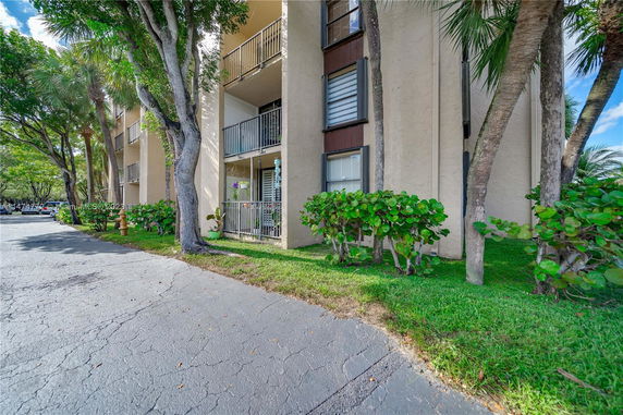 Front view of a multi-story residential building with balconies.