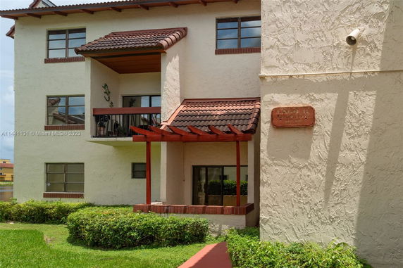 Front view of a multi-story building with balconies.