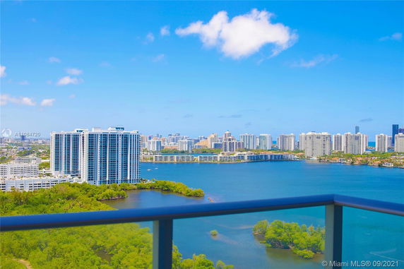 Wide-angle view of high-rise buildings and water from a high vantage point.
