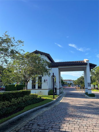 Entrance gate of a residential building with a covered archway and pathway.