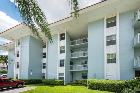 Front view of a multi-story residential building with balconies.