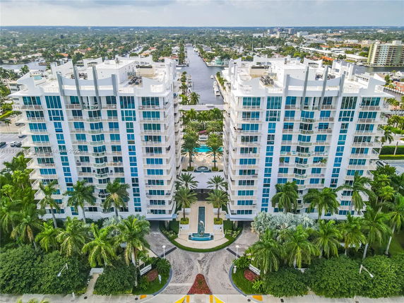 Front view of two high-rise residential buildings with glass balconies.