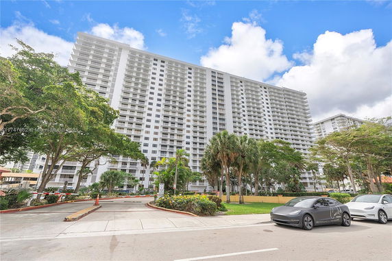 Front view of a multi-story residential building with balconies.