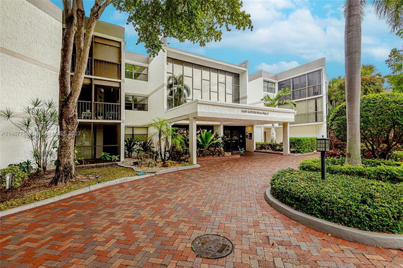 Front view of a multi-story building with a covered entrance.