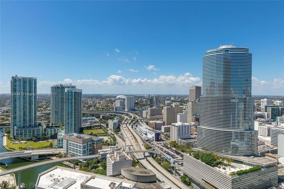 Panoramic view of a cityscape with multiple high-rise buildings and highways.