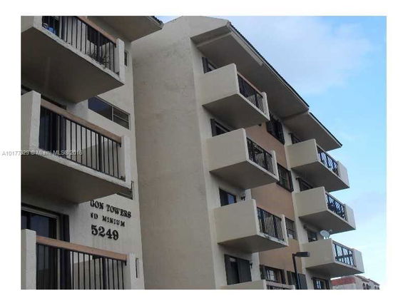 Front view of a multi-story apartment building with balconies.